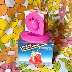 Vintage NOS space age orb rotating desk organizer in pink. Comes with original box & note paper.