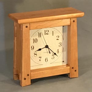 Arts & Crafts clock made in beautiful cherry wood with walnut pegs.  Quartz battery operated clock, continuous sweep hands and classic face.