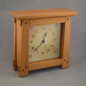 Arts & Crafts clock made in beautiful cherry wood with walnut pegs.  Quartz battery operated clock, continuous sweep hands and classic face.