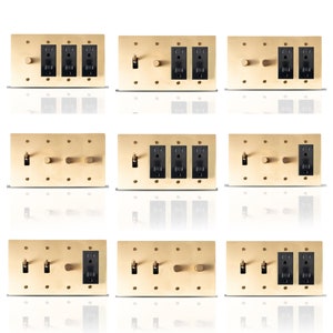 May include: Nine different variations of a brass light switch plate with black electrical outlets and toggle switches. Some plates have a single knob, others have two knobs, and some have three knobs.