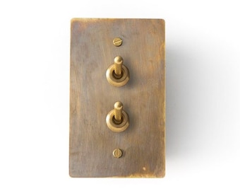 Light switch with antique brass plate