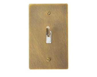 May include: A brass light switch with a white toggle switch. The switch plate has a brushed finish.