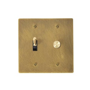 May include: A brass light switch and dimmer combination plate with a toggle switch and a round knob.
