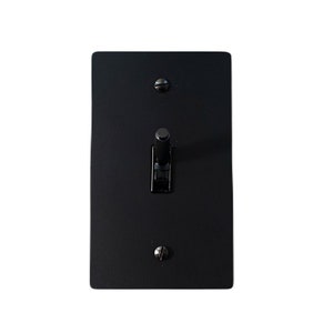 May include: A black light switch with a toggle switch in the off position.
