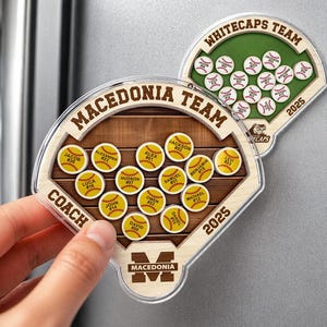 May include: Two baseball-themed magnets. One magnet reads "Macedonia Team" and the other reads "Whitecaps Team". Each magnet has a baseball field design with player names and numbers. The year "2025" is printed on both.