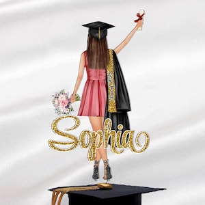 May include: A graduation cake topper featuring a woman in a black cap and gown, holding a diploma and flowers. The topper is decorated with gold glitter and the name "Sophia".