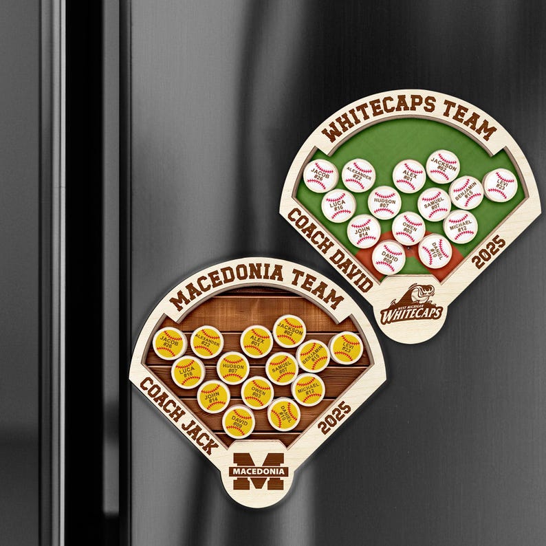 May include: Two wooden baseball-themed magnets. One features a green field with white baseballs and the text "Whitecaps Team" and "Coach David". The other has a brown field with yellow baseballs and the text "Macedonia Team" and "Coach Jack". Both have the year 2025.