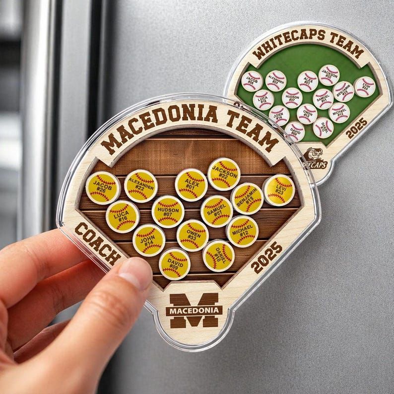 May include: Two baseball-themed magnets. One magnet reads "Macedonia Team" and the other reads "Whitecaps Team". Each magnet has a baseball field design with player names and numbers. The year "2025" is printed on both.