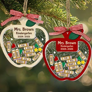 May include: Two apple-shaped ornaments with red and white gingham bows. One is white with a clear center, the other is red. Both have the text "Mrs. Brown Kindergarten 2024-2025" and student names on pencils.