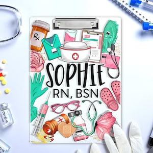 May include: A white clipboard with a colorful illustration of medical supplies and the text "SOPHIE RN, BSN". The illustration includes a stethoscope, a syringe, a bandage, a pair of glasses, a pill bottle, a butterfly, and a pair of pink clogs.