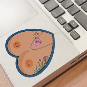 May include: A heart-shaped sticker with a blue outline, featuring a stylized illustration of a female torso with floral details. The flowers are pink, green, and yellow.