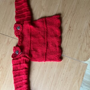 Red hand-knitted sweater for baby