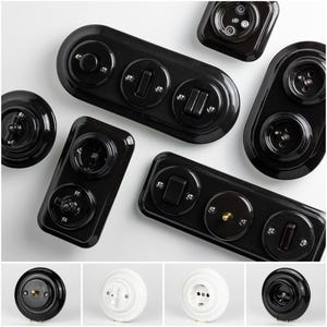 May include: An assortment of black electrical outlets and light switches. The switches and outlets are in various shapes and sizes, including round, rectangular, and oblong. The outlets and switches are made of a glossy black material and have a vintage aesthetic.