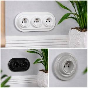 May include: A collection of electrical wall sockets featuring a white triple-socket plate, a black double-socket plate, and a single-socket circular plate. Each unit has a raised, stepped design with metallic grounding pins and circular ports.