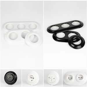 May include: A collection of electrical outlet covers and light switch plates in black and white. The image shows various shapes, including oval and circular designs. The products are made of a glossy material and are designed for home electrical systems.