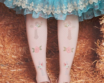 May include: A pair of white fishnet tights with a floral cross design. The tights are worn by a person wearing brown glitter shoes with a bow.