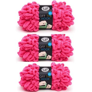 May include: Three skeins of pink yarn labeled "Off the Hook" yarn. The yarn is a fluffy, textured style.