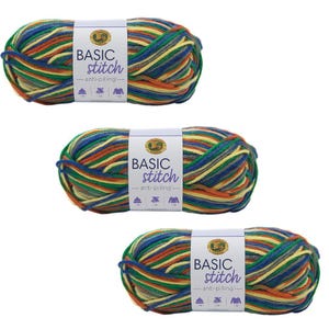 May include: Three skeins of yarn in a multi-colored pattern of orange, yellow, green, blue, and brown. The yarn is labeled "BASIC stitch anti-pilling..."