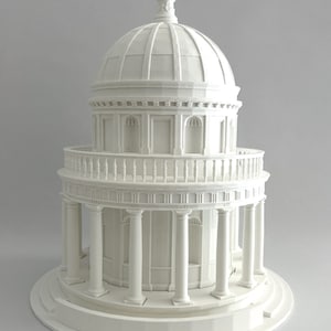 May include: A white 3D printed model of a small, domed building with columns and a balcony. The model is detailed and realistic, with intricate architectural features.