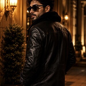 May include: A black leather jacket with a fur collar. The jacket has a classic design with visible stitching and a tailored fit. The image is taken at night, with street lamps in the background.