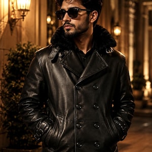 May include: A black leather double-breasted coat with a faux fur collar. The coat features a notched lapel, button closures, and side pockets. The person in the image is wearing sunglasses.