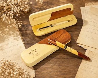 May include: Two wooden pens and two matching wooden cases. One pen is light-colored with gold accents and the name Elisa. The other pen features a two-tone wood design with the name Taylor. One case is open, and one is closed with Y|V and Yilia 12.21.26.