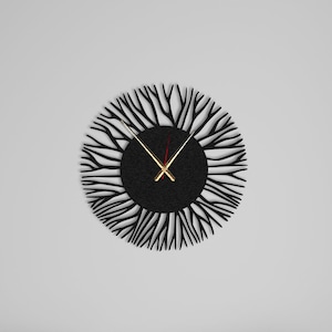May include: A black wall clock with a unique design featuring a circular frame with a black centre and a pattern of thin black lines radiating outwards. The clock hands are gold and red.