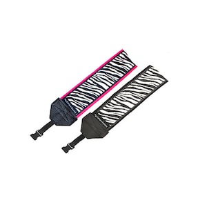 May include: Two black and white zebra patterned camera straps with pink and black trim. The straps have a black leather pad with the text "My Camera Strap" printed on them.