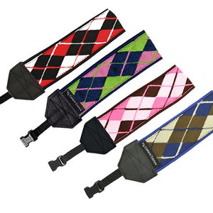 May include: Four camera straps with different colored argyle patterns. The straps are black, red, green, and brown with white accents. Each strap has a black adjustable strap with the text "My Camera Strap" printed on it.