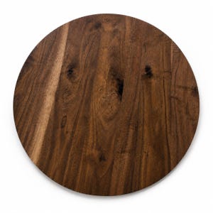 May include: A circular wooden board featuring a rich, dark brown finish with visible natural wood grain patterns, knots, and variations in tone throughout the surface, presenting a smooth, flat, and solid construction with a clean, rounded edge.
