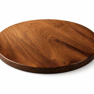 May include: A round, wooden cutting board with a rich, dark brown color and visible wood grain. The board is approximately 12 inches in diameter and has a smooth, polished finish. The edges are slightly rounded.
