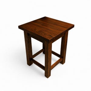 May include: A small, square wooden stool with a rich, dark brown finish. The stool has a simple design with four sturdy legs and a flat top. The legs are connected by a lower frame for added stability. The overall height is approximately 18 inches.