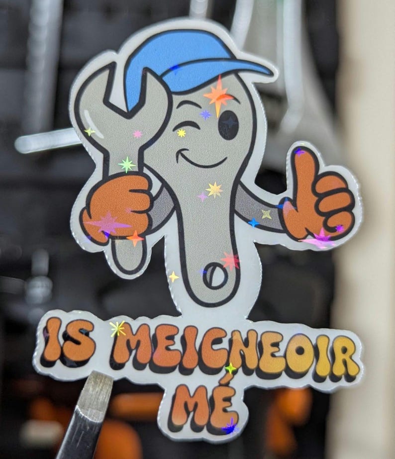 mechanic sticker of a spanner character in a baseball cap, holding a spanner giving a thumbs up and winking.