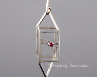 Colgante geométrico de plata de ley con detalles de rubí: joyería arquitectónica moderna, piedra natal de julio.