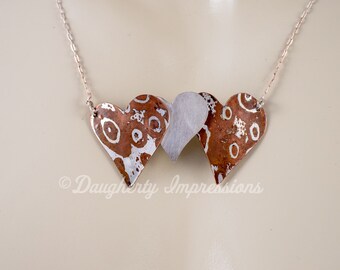 Collar con forma de corazón de Mokume Gane: Cobre y plata, amor eterno.