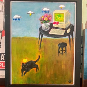 May include: A framed painting depicts a black cat running on green grass under a sun icon. A black table holds a vintage computer, a keyboard, a mouse, and a vase of colorful flowers. Above, clouds with rain and lightning bolts float in a blue sky.