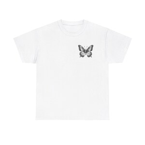 May include: White t-shirt with a black and white butterfly graphic on the front.