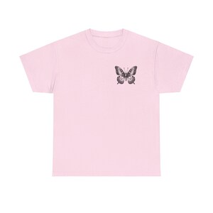 May include: A pink t-shirt with a black butterfly graphic on the front.