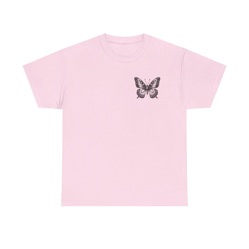 May include: A pink t-shirt with a black butterfly graphic on the front.