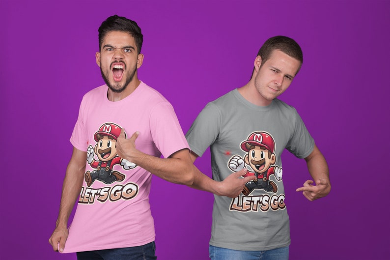 May include: Two people wearing t-shirts with a cartoon character running and the text "Let's Go". One shirt is pink and the other is gray.