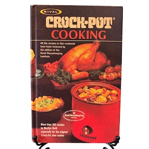 May include: Vintage cookbook titled "Crock-Pot Cooking" by Marilyn Neill. The cover features a roasted chicken, vegetables, and a red Crock-Pot slow cooker. The book promises over 300 recipes and is endorsed by Good Housekeeping.
