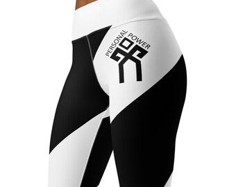 May include: Black and white athletic leggings with a geometric design. The leggings feature a high waistband and the words "PERSONAL POWER" with a graphic logo printed on the side. The leggings are made of a stretchy material.
