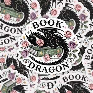 May include: A black and white sticker with a black dragon curled around a green book with the text "Dragon Flight 101". The dragon is sleeping on the book with its head resting on a pink rose. The sticker is surrounded by pink and purple roses and green leaves.
