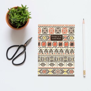 May include: A notebook with a colorful geometric pattern on the cover. The text "Things to do insha'Allah" is printed on the cover.