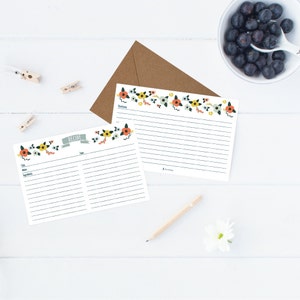 Puede incluir: Dos tarjetas de recetas imprimibles con un borde floral. Las tarjetas tienen líneas para escribir el título, los ingredientes, las instrucciones y el tiempo. Las tarjetas son blancas con un borde floral en tonos naranja, amarillo, azul y verde.
