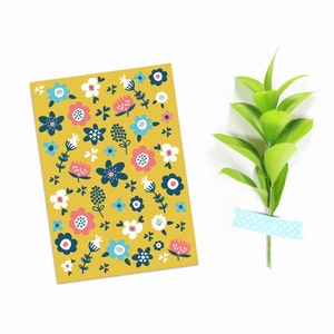 May include: A yellow card with a repeating pattern of blue, pink, and white flowers. The flowers are stylized and have a simple, modern design.