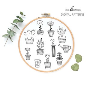 May include: A black and white illustration of potted plants and a watering can. The illustration is inside a wooden embroidery hoop. The text "Ink & Ocean DIGITAL PATTERNS" is at the top of the image.