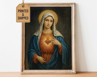 May include: Framed religious artwork featuring a portrait of a woman with a halo. She wears a white veil, blue robe, and a red bodice. A flaming heart is visible on her chest. The artwork is in a wooden frame.
