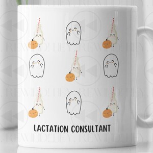 May include: A white ceramic mug featuring a repeating pattern of cartoon ghosts and milk bottles with orange pumpkins. The text LACTATION CONSULTANT is printed in black capital letters near the bottom of the mug, which has a curved handle.