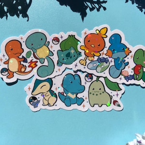 May include: A set of ten holographic stickers featuring various Pokemon characters. The stickers are on a white background and feature a variety of colours, including blue, green, red, and orange. The stickers are perfect for adding a touch of whimsy to laptops, water bottles, or journals.